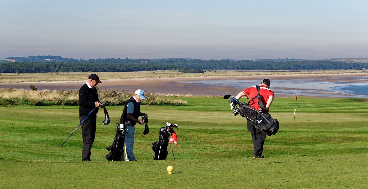 Photo of golfers on a golf course.