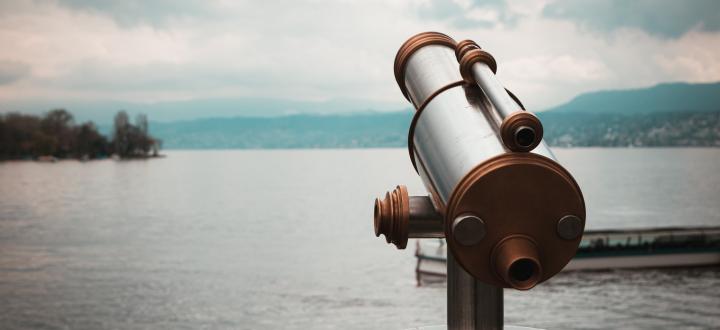 Photo of a telescope looking out over a lake