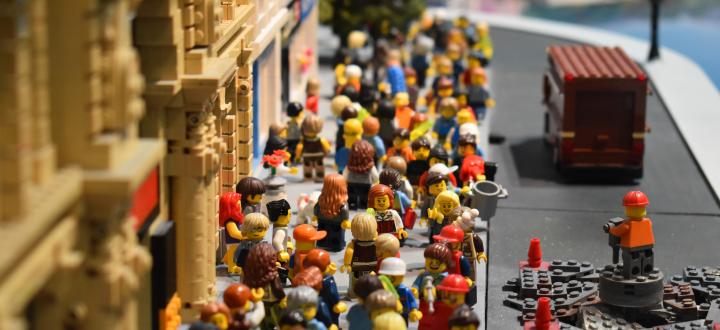 A collection of lego figures outside a building