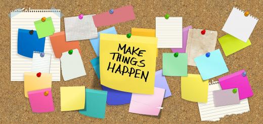 Image of cork board with multiple coloured sticky notes and a large yellow note in the centre with 'Make Things Happen' written in black ink.