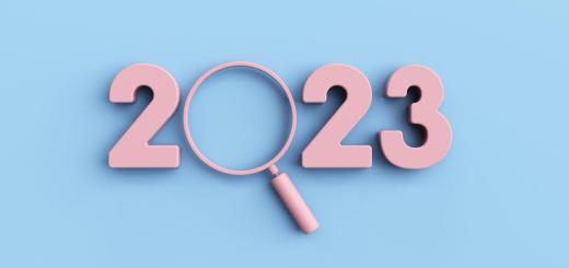 Blue background with the pink numbers 2, 2 and 3 and a pink magnifying glass making the 0 for 2023.