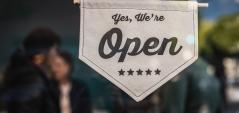 Photo of a sign saying 'yes, we're open'